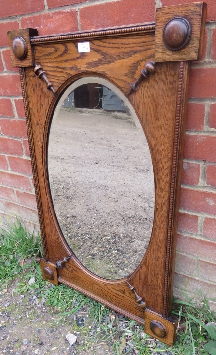 A 1920s oval bevelled wall mirror, within a rectangular medium oak frame with split moulding applied - Image 2 of 2