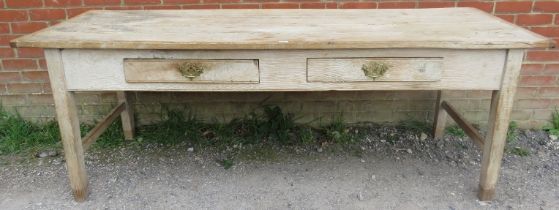 An antique scrubbed elm farmhouse kitchen table, having two short frieze drawers with brass handles,