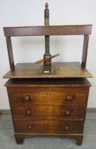 An early 19th century oak chest of small proportions with clothes press, housing three long