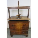 An early 19th century oak chest of small proportions with clothes press, housing three long
