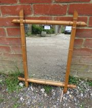 A vintage rectangular wall mirror within a faux bamboo beech surround. H65cm W51cm D3cm (approx).