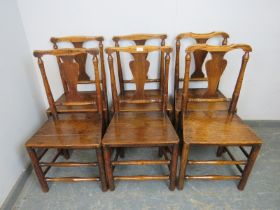 A matched set of six 18th century elm dining chairs of excellent colour, having shaped back-splats