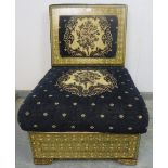 A highly decorative ottoman seat, upholstered in navy material with tapestry decoration, the back