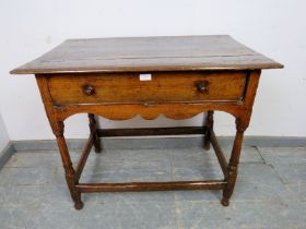 A late 17th early 18th century ash side table, housing one long frieze drawer with turned wooden