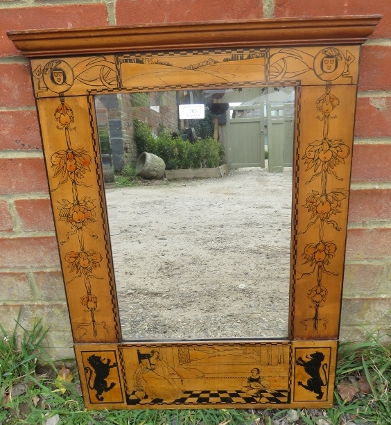 An unusual Arts & Crafts Period bevelled wall mirror, the walnut surround with stepped cornice and