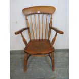 A 19th century elm & beech Windsor fireside chair, on canted turned supports with an ‘H’