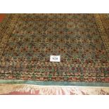 A 20th century Persian rug, central repeat patter on blue ground. 240cm x 160cm max (approx).