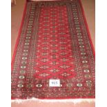 A 20th Persian rug, central field of repeat pattern on red ground. 163cm x 96cm (approx).