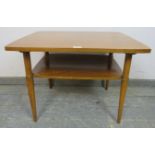 A mid-century walnut two-tier coffee table, on tapering supports. H53cm W70cm D56cm (approx).