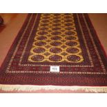 A Persian rug, central repeat pattern on cream ground on red, with wide borders. 181cm x 127cm (