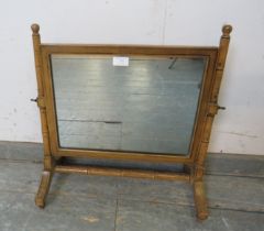 A Regency Period faux bamboo swing vanity mirror, retaining the original polychrome paintwork, on