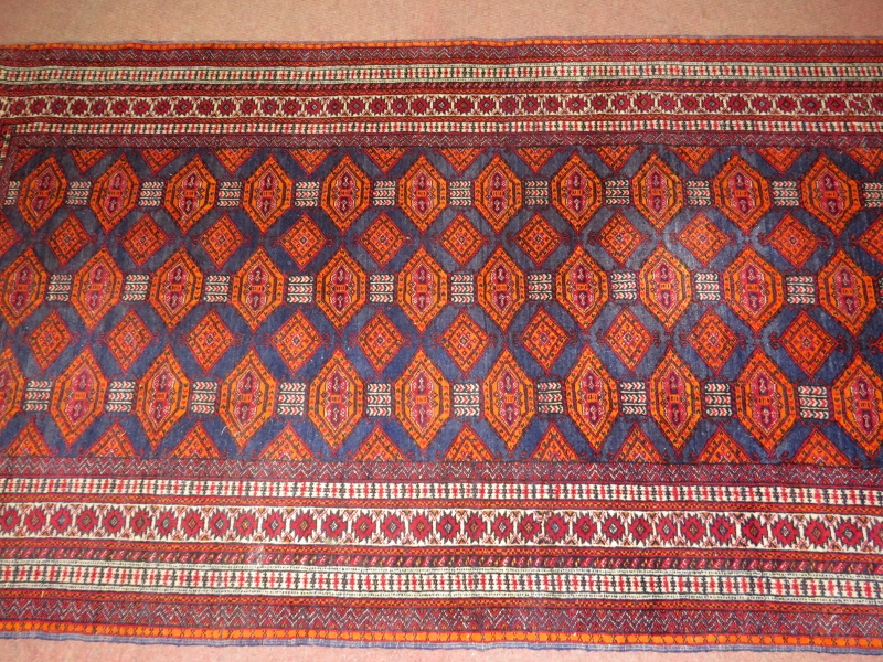 A 20th century Persian rug, central field of repeat pattern, orange/red on blue ground. 180cm x 96cm - Image 3 of 3