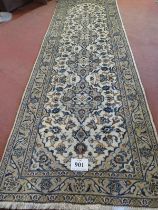 A central Persian Kashan runner, four central motifs on a cream ground. 300cm x 100cm (approx).