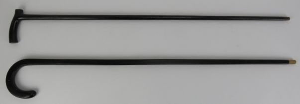 Two ebonised wood walking canes, late 19th century or later. (2 items) 92 cm length, 90.5 cm length.