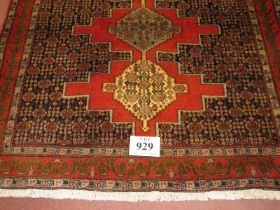 North West Persian Senneh rug, three central locking motifs surrounded by repeat pattern, salmon