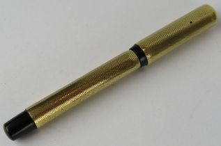 A small 14ct gold retractable fountain pen, possibly by Mont Blanc. The cap is marked 585 and the