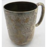 A silver christening mug with 'C' shaped handle and foliate engraved decoration, monogrammed,