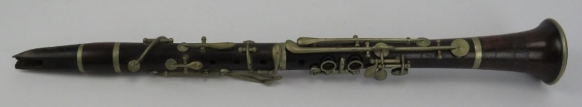 A Victorian rosewood clarinet by E Albert of Brussels, Belgium. cm length. Condition report: Some