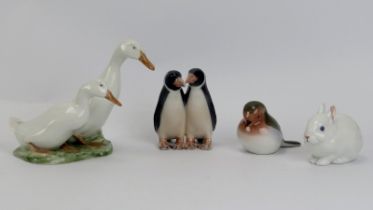 A group of four Royal Copenhagen porcelain figurines. Comprising a figural group of two geese,