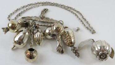 A traditional silver Brazilian Balangandam amulet with good luck charm pendants including fruits,