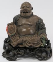 A Chinese carved and lacquered wood statue of Buddha, early 20th century. Supported on a gnarled
