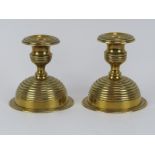 A pair of Arts & Crafts brass candlesticks, late 19th/early 20th century. With detachable