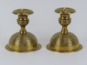 A pair of Arts & Crafts brass candlesticks, late 19th/early 20th century. With detachable