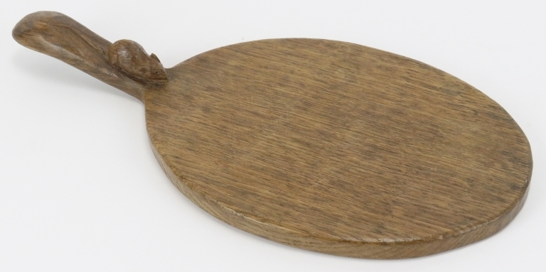 A Robert ‘Mouseman’ Thompson English oak cheeseboard. Of oval form with the trademark mouse carved