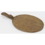 A Robert ‘Mouseman’ Thompson English oak cheeseboard. Of oval form with the trademark mouse carved