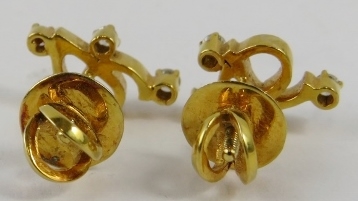 A pair of yellow precious metal and diamond earstuds of abstract design, set with approximately 0. - Image 2 of 2