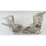 A pair of Middle Eastern white metal fighting cockerel figures, each bearing a .900 mark in