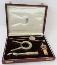 A 1970s Asprey & Co silver plated cocktail bar set in fitted case including ice tongs, champagne