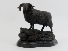 A bronze metal figure of a ram on a rocky outcrop, 20th century. Supported on a marble base. 21.3 cm