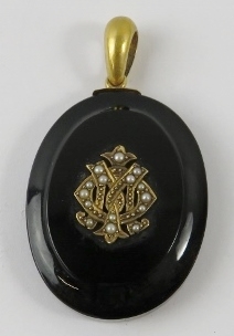 A Victorian onyx and seed pearl mourning locket with woven hair panel to reverse and hoop bale