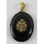 A Victorian onyx and seed pearl mourning locket with woven hair panel to reverse and hoop bale