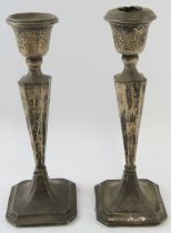 A pair of silver square form candlesticks, hallmarked for Chester 1923, maker Robert Pringle & sons.