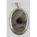 A moss agate ‘Landscape’ pendant in oval white metal frame, 5cm overall, gross weight 12gms approx