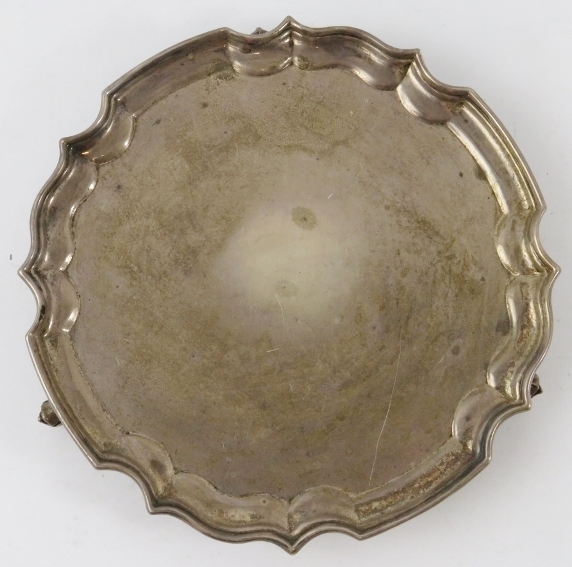 A small silver salver card tray with piecrust edge and standing on three foliate feet. Hallmarked - Image 2 of 4