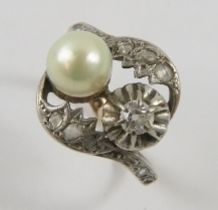 A diamond and Mallorcan pearl toi et moi dress ring, set with a pearl and old cut diamond