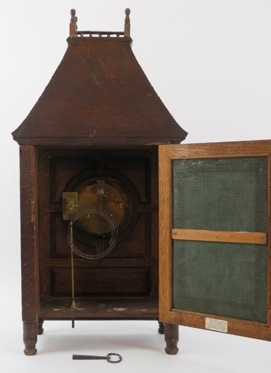 A large carved oak bracket clock, late 19th/early 20th century. With blue and white enamelled - Image 3 of 5