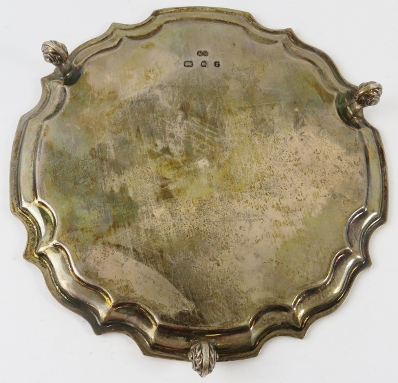 A small silver salver card tray with piecrust edge and standing on three foliate feet. Hallmarked - Image 3 of 4