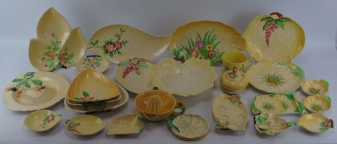A large group of Carlton Ware porcelain wares. A variety of patterns decorated against a yellow