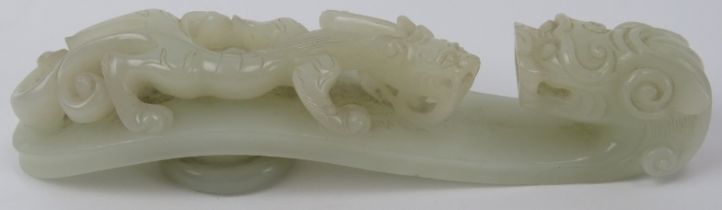 A Chinese celadon jade dragon belt hook, 18th/19th century. Finely carved depicting a chilong dragon