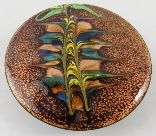 A Decorative Art Nouveau style enamelled copper plaque, the circular domed plaque 8cm diameter and