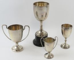 Four silver sports trophies, two with handles. All fully hallmarked. Tallest 15.5cm. Gross silver