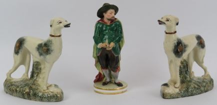 Two Staffordshire porcelain greyhounds and a Derby porcelain works figurine, 19th century. Derby