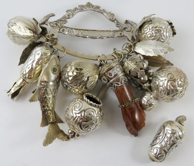 A traditional silver Brazilian Balangandam amulet with good luck charm pendants including fruits,