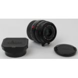 A Leica Summarit-M 1:2.5 / 35mm E39 black camera lens. With caps, hood for 35mm & 50mm f/2.5,