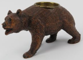 A Black Forest carved wood bear with brass bowl. Modelled with glass eyes. Possibly to be utilised