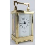 An English David Peterson brass eleven jewels carriage clock. Key included. 13 cm height.